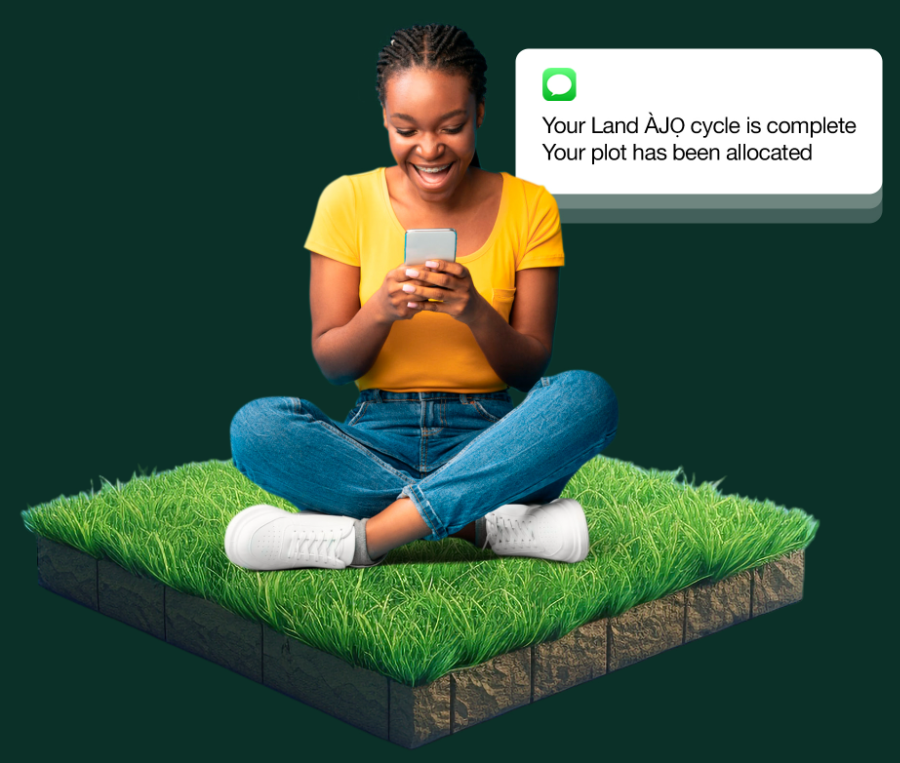Nigerian woman smiling at her phone on her newly allocated land plot